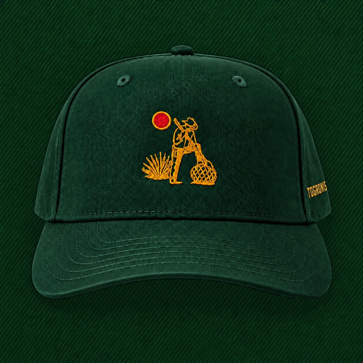 The Jimador Hat from the front: hunter green, with the gold jimador and red sun embroidered on the front and TOGRONIS on the side